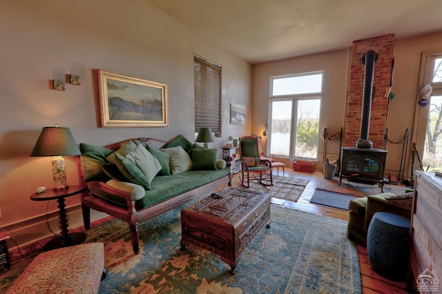 380 Main St, New Baltimore, NY 12124 - living room featuring a wood stove, plenty of natural light, and wood finished floors