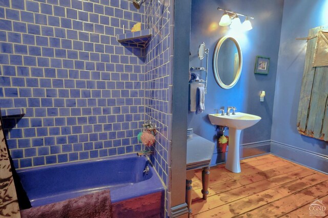 380 Main St, New Baltimore, NY 12124 - bathroom featuring hardwood / wood-style flooring, shower / bathtub combination, and baseboards