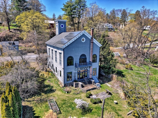 380 Main St, New Baltimore, NY 12124 - back of house with a balcony, a chimney, and view of wooded area