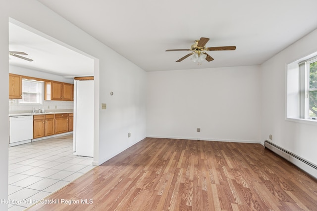 109 Union St, Middleburgh, NY 12122 - empty room with a ceiling fan, a baseboard radiator, healthy amount of natural light, and light wood-style flooring