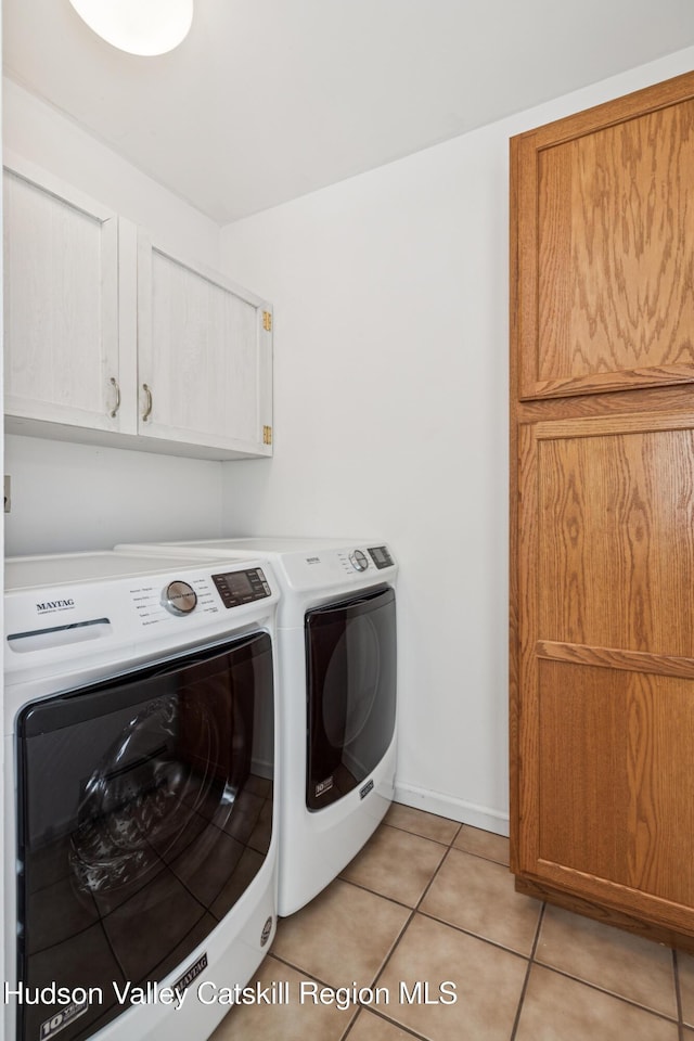 109 Union St, Middleburgh, NY 12122 - laundry room with washing machine and dryer, cabinet space, and light tile patterned flooring
