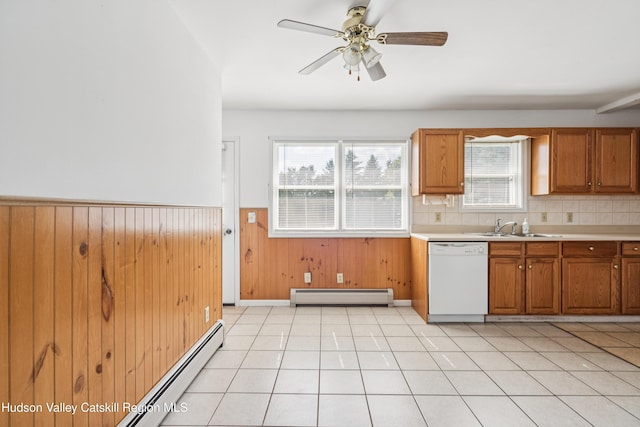 109 Union St, Middleburgh, NY 12122 - kitchen with dishwasher, a baseboard radiator, brown cabinetry, light countertops, and wainscoting