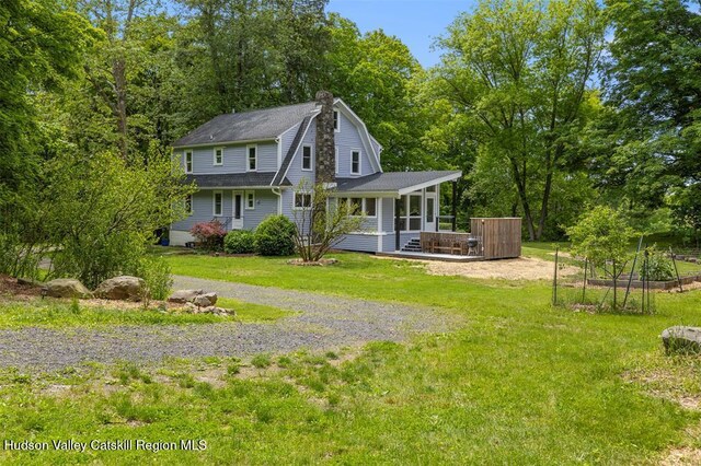 370 N Elting Corners Rd, Highland, NY 12528 - back of property featuring a lawn, a gambrel roof, a shingled roof, a chimney, and a deck