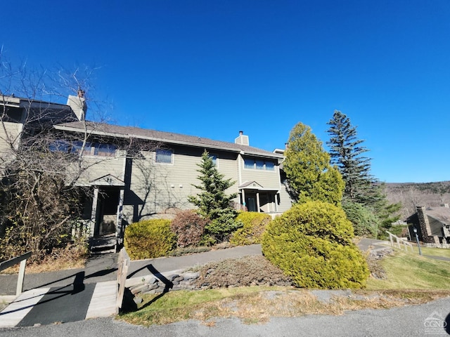 56 Highlands Dr Unit F-5, Hunter, NY 12442 - view of home's exterior with a chimney