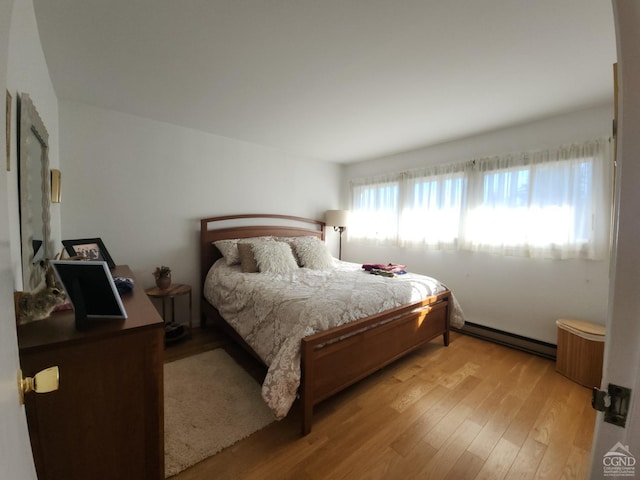 56 Highlands Dr Unit F-5, Hunter, NY 12442 - bedroom featuring a baseboard heating unit and light wood-type flooring