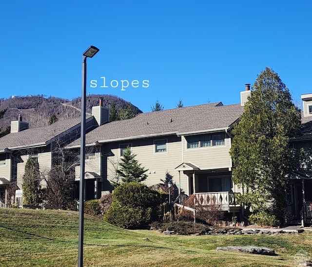 56 Highlands Dr Unit F-5, Hunter, NY 12442 - rear view of house featuring a chimney and a lawn