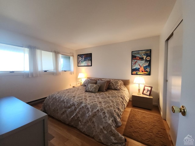 56 Highlands Dr Unit F-5, Hunter, NY 12442 - bedroom featuring baseboard heating and wood finished floors