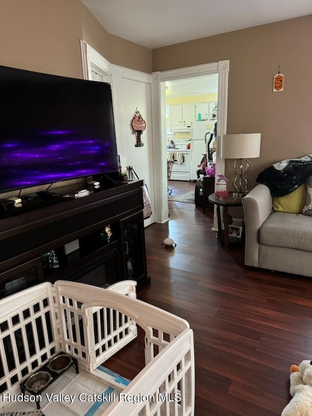 living room featuring dark hardwood / wood-style flooring and independent washer and dryer