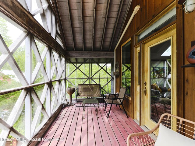 unfurnished sunroom with lofted ceiling and wood ceiling