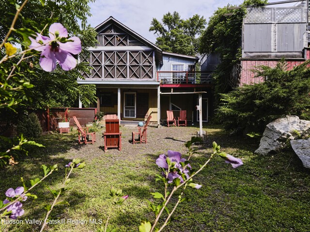 rear view of property with a wooden deck