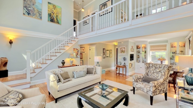 50 Manhattoes Dr, Athens, NY 12015 - living area featuring stairway, a towering ceiling, wood finished floors, and baseboards