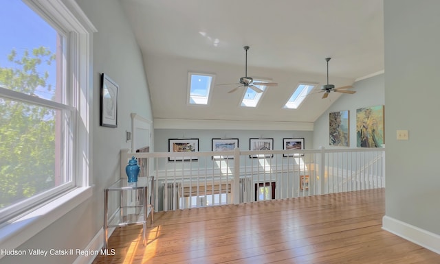 50 Manhattoes Dr, Athens, NY 12015 - unfurnished dining area featuring ceiling fan, a skylight, wood finished floors, baseboards, and high vaulted ceiling