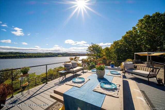 view of patio / terrace with an outdoor hangout area and a water view