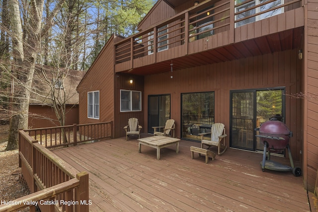 wooden deck with a grill