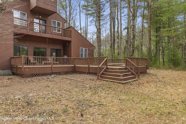 exterior space featuring a wooden deck and a balcony
