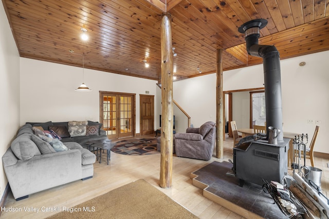 living room featuring french doors, wooden ceiling, wood finished floors, and a wood stove