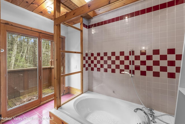 bathroom featuring a bath and tile patterned flooring
