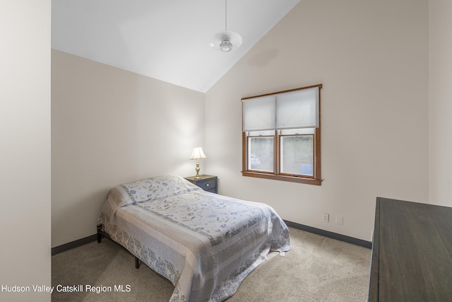 bedroom featuring baseboards, carpet flooring, and high vaulted ceiling