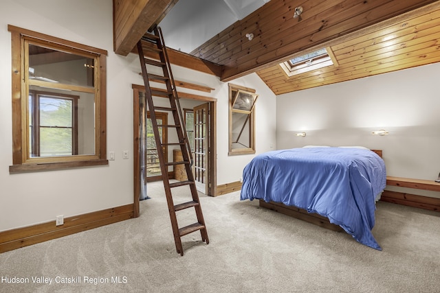 carpeted bedroom with lofted ceiling with skylight, baseboards, and wooden ceiling