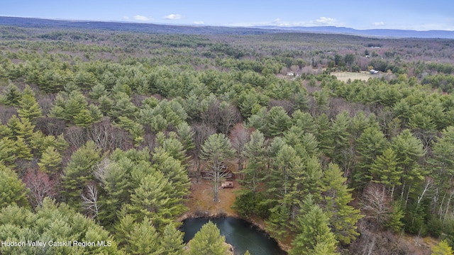 aerial view with a forest view and a water view