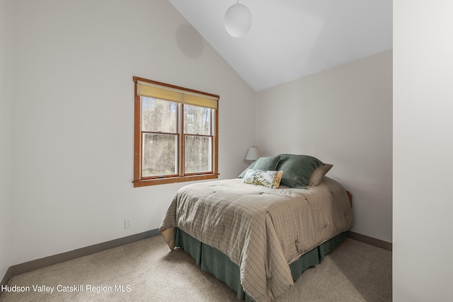 bedroom featuring baseboards, vaulted ceiling, and carpet flooring