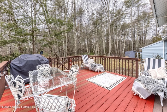 deck with area for grilling and outdoor dining space