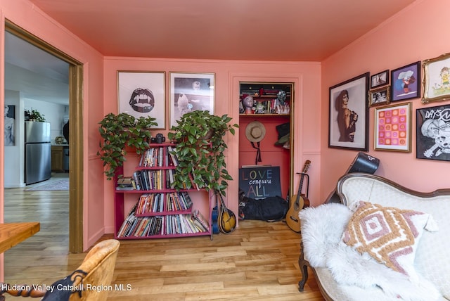 interior space featuring wood finished floors and ornamental molding