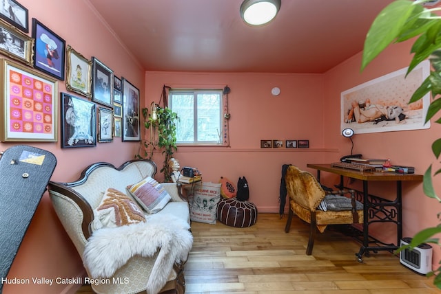 home office with crown molding and wood finished floors