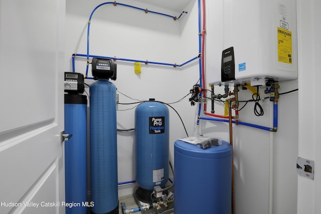 utility room featuring water heater