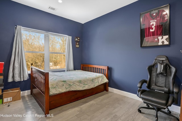 bedroom with wood-type flooring