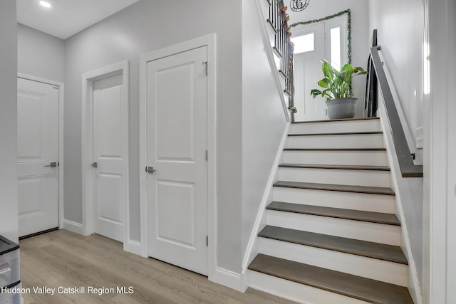 staircase with hardwood / wood-style flooring