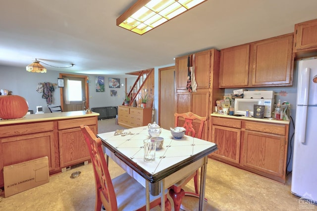 568 State Route 145, Middleburgh, NY 12122 - kitchen featuring white appliances, brown cabinets, and tile countertops