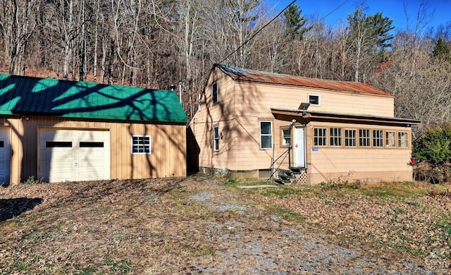 568 State Route 145, Middleburgh, NY 12122 - view of front facade featuring entry steps, metal roof, an outbuilding, and a detached garage