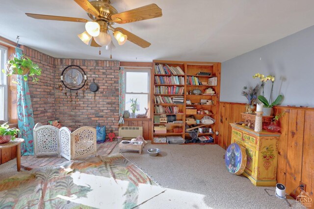 568 State Route 145, Middleburgh, NY 12122 - carpeted living area with healthy amount of natural light, a wainscoted wall, ceiling fan, and wooden walls