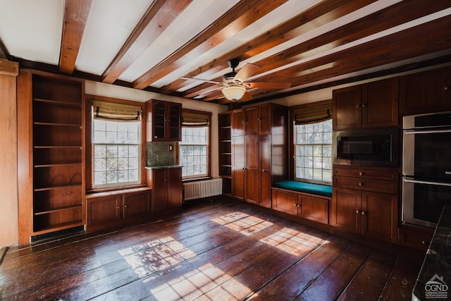 21 Cemetery Rd, New Lebanon, NY 12125 - kitchen with double oven, radiator heating unit, black microwave, dark wood-type flooring, and beam ceiling