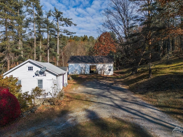 21 Cemetery Rd, New Lebanon, NY 12125 - view of front facade featuring driveway and a view of trees