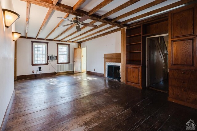 21 Cemetery Rd, New Lebanon, NY 12125 - unfurnished living room with a fireplace, ceiling fan, dark wood-type flooring, and beamed ceiling