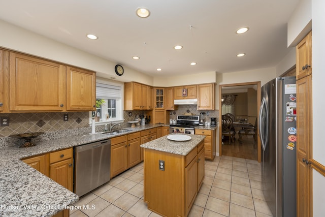 368 Gahbauer Rd, Hudson, NY 12534 - kitchen with stainless steel appliances, under cabinet range hood, backsplash, a kitchen island, and light stone countertops