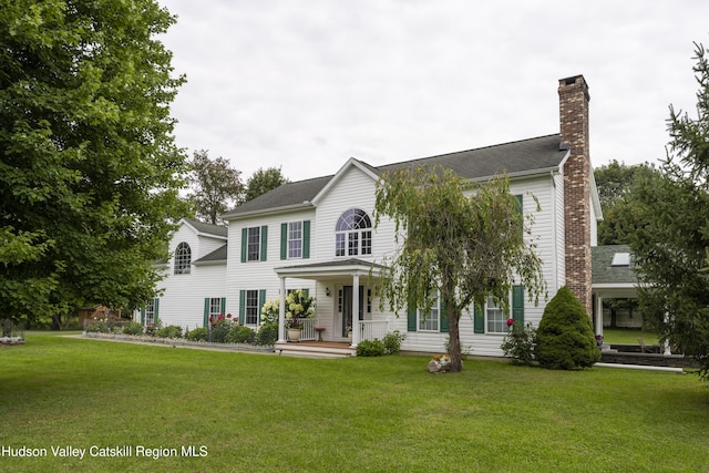 368 Gahbauer Rd, Hudson, NY 12534 - colonial-style house with covered porch, a chimney, and a front yard