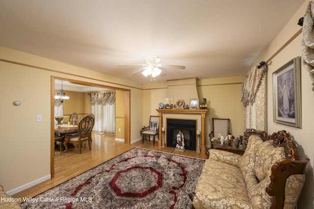 368 Gahbauer Rd, Hudson, NY 12534 - living area featuring wood finished floors, a chandelier, ceiling fan, and a fireplace with flush hearth