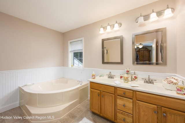 368 Gahbauer Rd, Hudson, NY 12534 - bathroom featuring double vanity, a wainscoted wall, a garden tub, and tile patterned floors