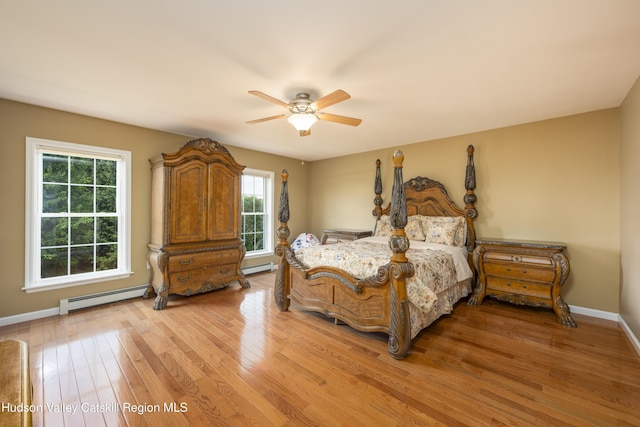 368 Gahbauer Rd, Hudson, NY 12534 - bedroom with a baseboard heating unit, light wood-style flooring, a baseboard radiator, and ceiling fan