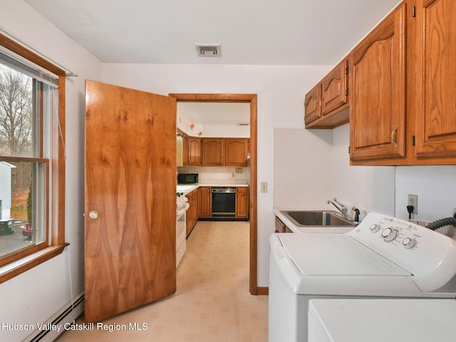 laundry room with washer and clothes dryer, cabinets, baseboard heating, and sink