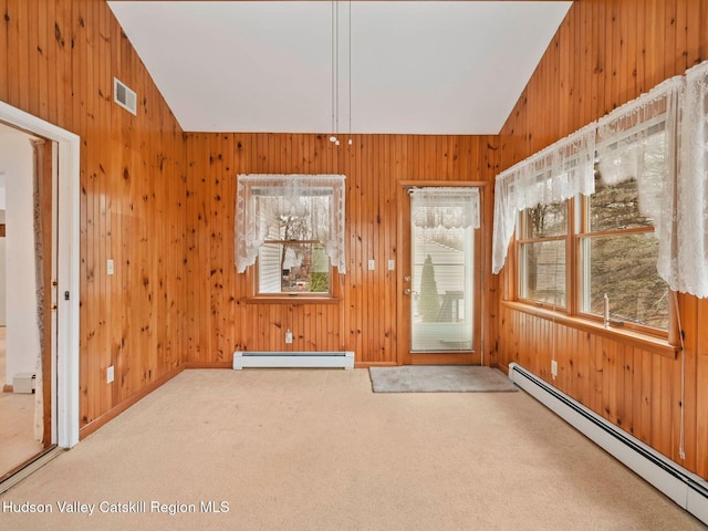 unfurnished sunroom with baseboard heating and lofted ceiling