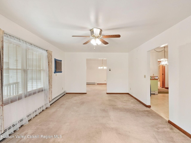 carpeted empty room with a baseboard radiator and ceiling fan with notable chandelier