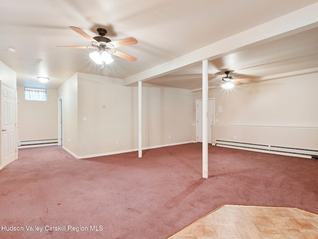 basement featuring carpet flooring, ceiling fan, and a baseboard heating unit