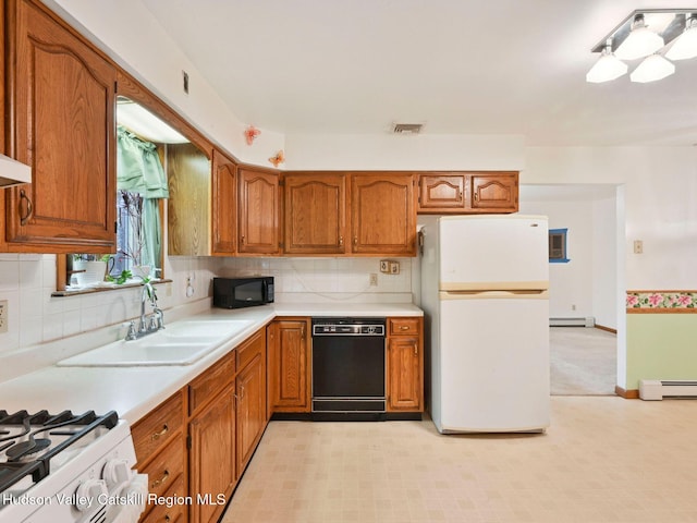 kitchen with backsplash, sink, black appliances, and a baseboard radiator