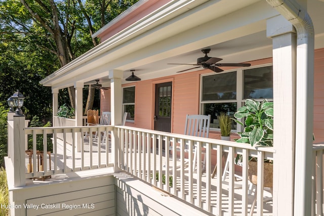 deck with ceiling fan and covered porch