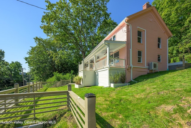 view of side of home with a yard