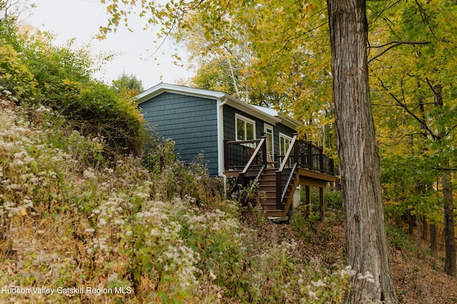 view of property exterior featuring a wooden deck